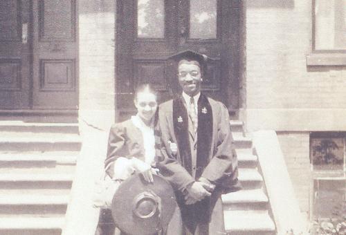 John Hope Franklin and Aurelia posing on John's graduation day, JHF is in a graduation cap and gown